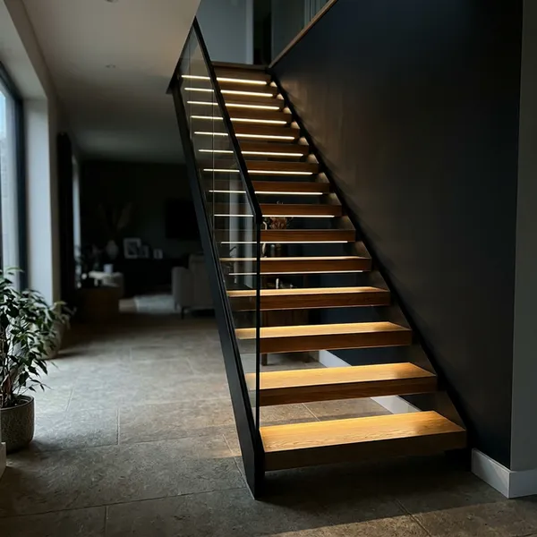 Concealed LED lighting glowing from inside a floating stair stringer in a Long Island home